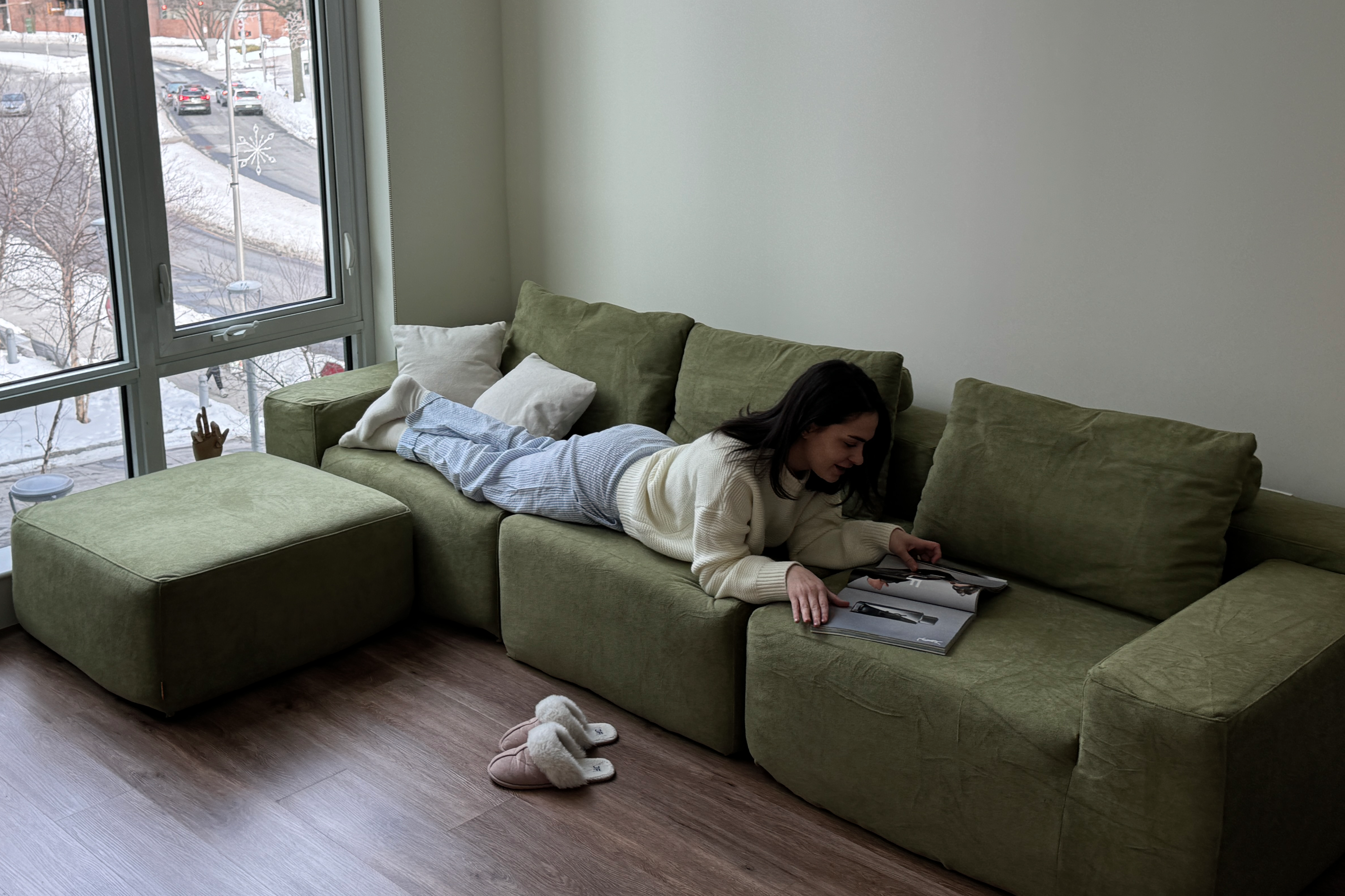 Five foot five person sitting on the Modu cube sofa