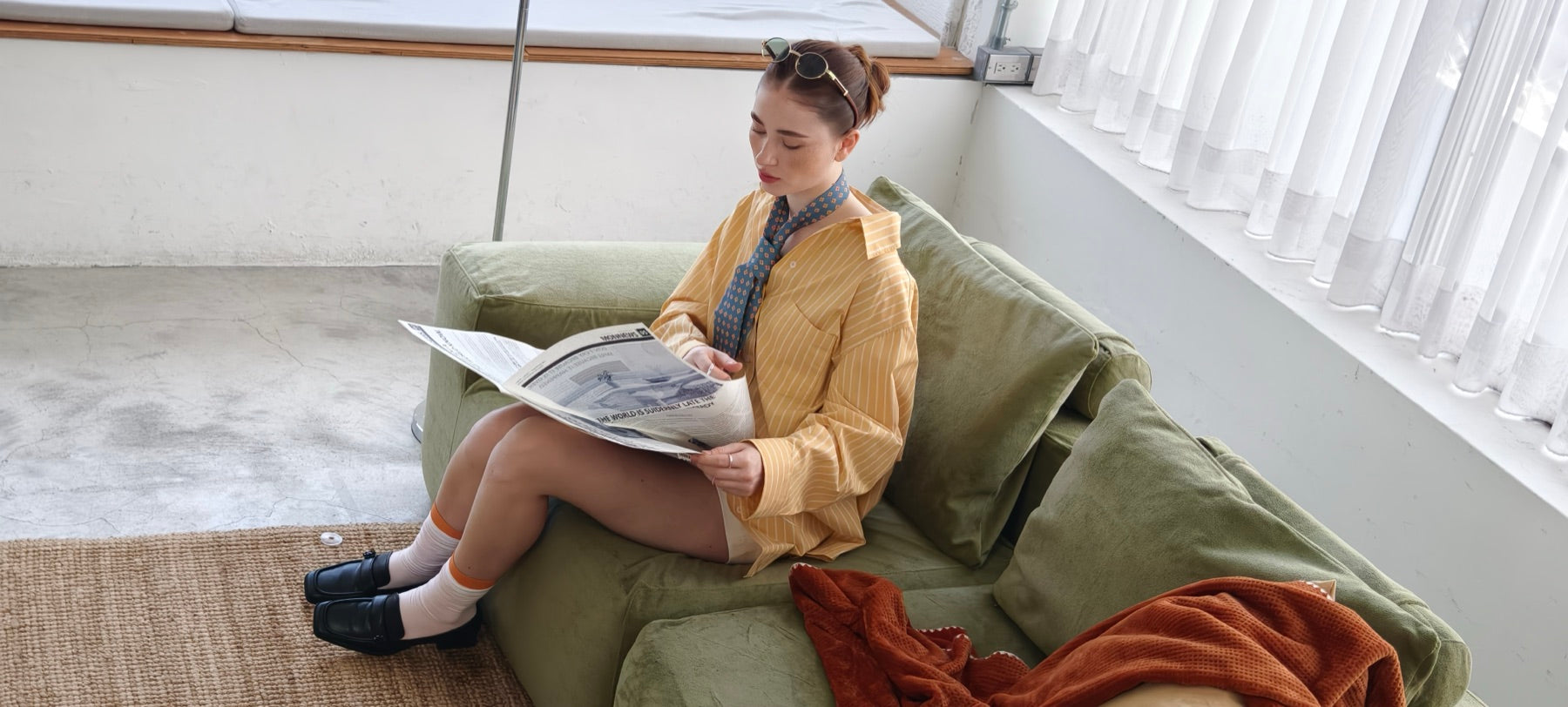 Five foot nine person sitting on the Modu cube sofa