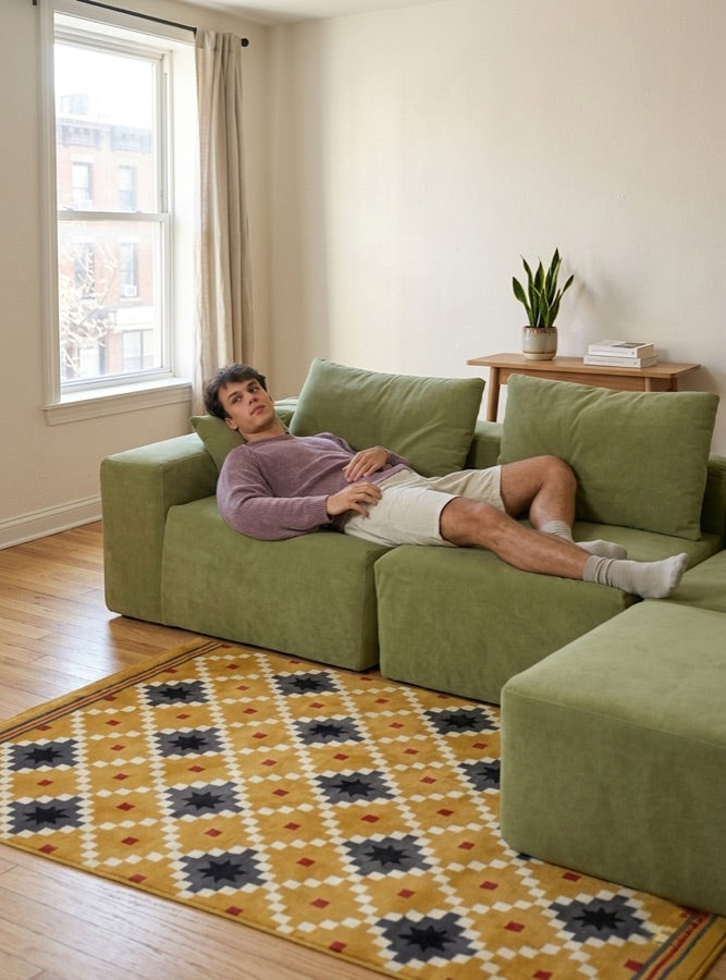 Five foot eleven person sitting on the Modu cube sofa