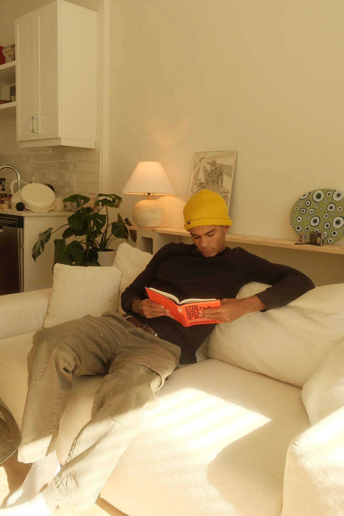 Person reading on a white Modu cube sofa
